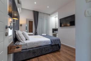 a bedroom with a bed and a flat screen tv at Antares Luxury Rooms 2 in Split