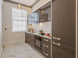 a kitchen with stainless steel appliances and a window at 1 Bed in Carlisle 92872 in Carlisle