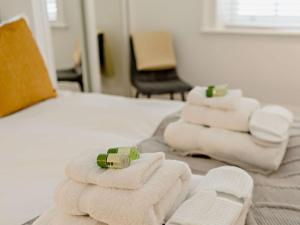 a pile of towels on a bed in a room at 1 Bed in Carlisle 92872 in Carlisle