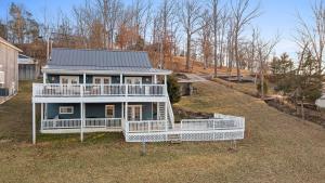 a large house with a large front porch and balcony at Cozy Blue Lake House in Williamstown