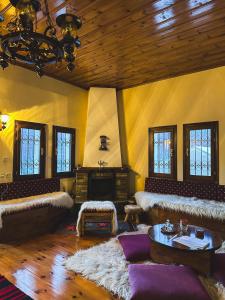 a living room with couches and a wooden ceiling at “White Mountain”, Pisoderi in Pisoderi