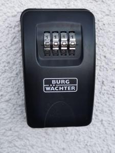 a black button with a bug watchdog on a wall at Ferienwohnung in der Natur in Ober-Hilbersheim