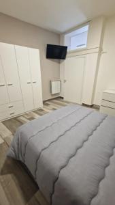 a large bedroom with white cabinets and a large bed at BB Corso Roma in San Giovanni Rotondo