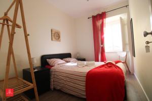 a bedroom with a bed and a ladder and a window at Casas da Biquinha in Sintra