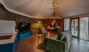 a room with a tent with a couch and a table at kMah@SomerMansion in Tanah Rata