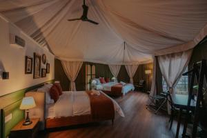a bedroom with two beds in a tent at kMah@SomerMansion in Tanah Rata +32 photos