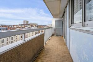 a balcony with a view of a city at Appartement Leroy balcon - Welkeys in Clichy