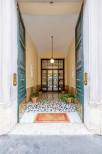 an entrance to a building with two green doors at Domus Castroni Scipioni in Rome