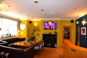 a living room with yellow walls and a fireplace at Dolphin Rooms in Cleethorpes