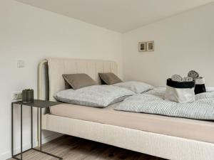 a bedroom with a large bed with a table at Scandi Micro House in Warstein