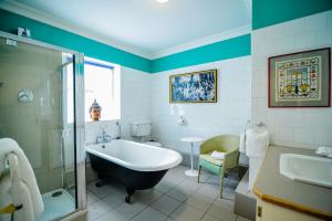 a bathroom with a tub and a shower and a sink at The Quay House, Clifden in Clifden +67 photos