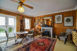a living room with a table and a fireplace at The Quay House, Clifden in Clifden