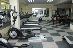 a gym with rows of treadmills and exercise bikes at Melka International Hotel in Addis Ababa