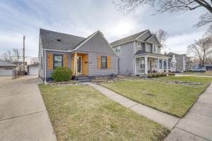 a gray house with a driveway in a residential neighborhood at Beautiful Berkley Home about 18 Mi to Downtown Detroit in Berkley