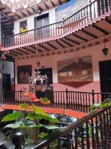 a room with a staircase with a chandelier at Hostal Juana de Arco in Quito