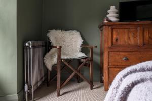 a room with a rocking chair and a television at Bryony Cottage: Close to Station in Windermere