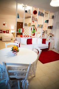un soggiorno con tavolo e sedie bianchi di B&B Flower House a Fasano