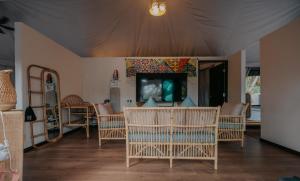 uma sala de estar com cadeiras e uma televisão de ecrã plano em kMah@Parkland em Brinchang
