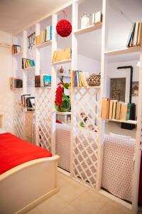 a room with bookshelves and a red bed at B&B Flower House in Fasano