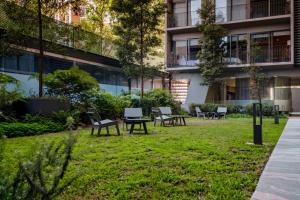 a park in front of a building at Lumina at Taman Condesa in Mexico City