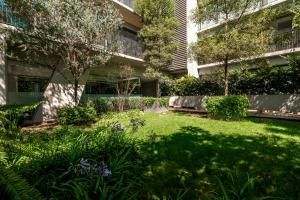 a garden in front of a building at Lumina at Taman Condesa in Mexico City