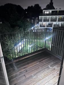 a balcony with a fence with lights on it at Private Flat in London in London