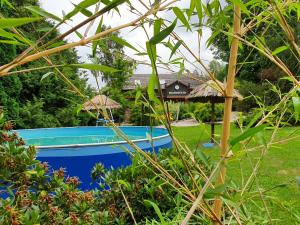 a blue boat in a yard with a house in the background at Chalupa EL DORADO in Chanovice