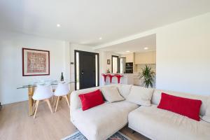 a living room with a white couch and red pillows at 2Agnes01 in Vidreres