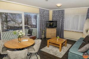 a living room with a couch and a table at Flairhotel am Wörthersee in Velden am Wörthersee