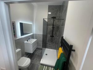 a small bathroom with a toilet and a sink at Clacton Chic in Clacton-on-Sea