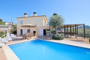 a villa with a swimming pool and a house at Villa Franci - Blanes in Blanes