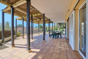 an empty patio with benches on a house at Villa Franci - Blanes in Blanes