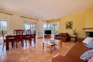 a living room with a table and a couch at Villa Franci - Blanes in Blanes