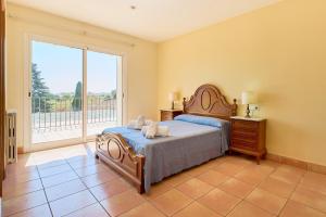 a bedroom with a bed and a large window at Villa Franci - Blanes in Blanes +24 photos