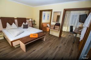 a hotel room with a bed and a mirror at Flairhotel am Wörthersee in Velden am Wörthersee