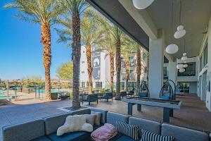 a patio with a ping pong table and palm trees at Shopping & Dining Dist-Resort Pool-Views-King Bed S439 in Scottsdale