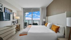 a bedroom with a large bed and a large window at 2 bed rental on the beach15th floor Hollywood Miami in Hallandale Beach +34 photos