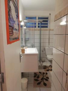 a bathroom with a sink and a toilet at Philippe & Arlette SMITH in Sainte-Luce