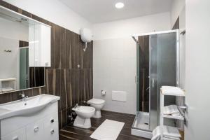 a bathroom with a toilet and a sink and a shower at Casa vacanze da Linda in Pignola