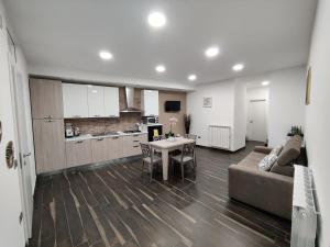 a living room with a couch and a table and a kitchen at Casa vacanze da Linda in Pignola