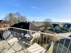 einen Balkon mit einem Tisch und Stühlen auf einer Terrasse in der Unterkunft Möwe in Insel Poel