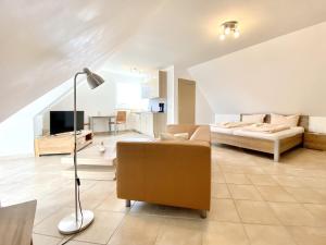 a living room with a couch and a bed at Appartementhaus Möwe in Kirchdorf