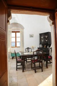 a dining room with a table and chairs at Tower of Dellarokas in Mélanes