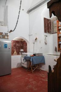 a kitchen with a table in the middle of a room at Tower of Dellarokas in Mélanes