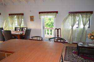 a dining room with a table and chairs and a window at Seaview Apartments in Cudjoe Head