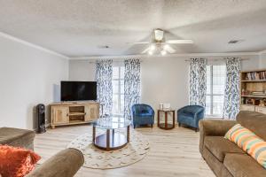 a living room with a couch and a tv at Pet-Friendly Millbrook Home with Covered Patio! in Millbrook