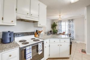 a kitchen with white cabinets and a stove at Pet-Friendly Millbrook Home with Covered Patio! in Millbrook