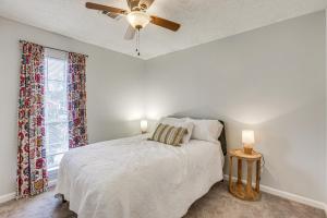 a bedroom with a bed with a ceiling fan and a window at Pet-Friendly Millbrook Home with Covered Patio! in Millbrook