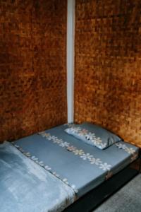 2 camas en una habitación con una pared de ladrillo en Villa Situ Patenggang, en Ciwidey