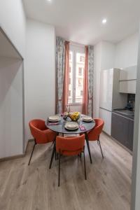 a dining room with a table and four chairs at Cola Suites Apartments in Rome